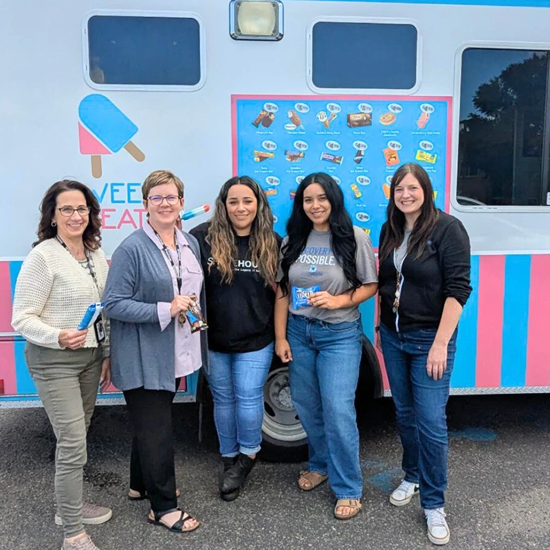ShareHouse team smiling in front of ice cream truck